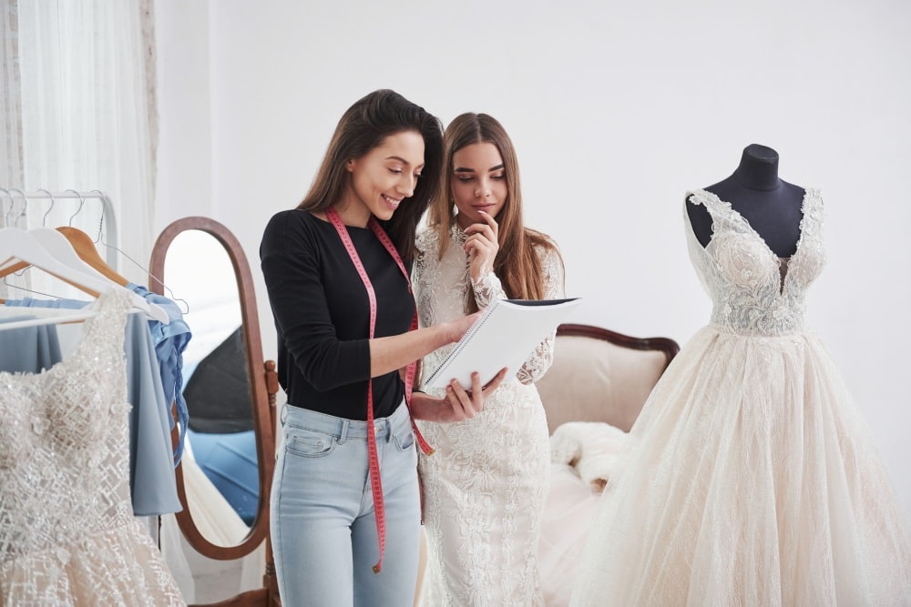 Bride having her wedding dress altered in a bridal boutique.