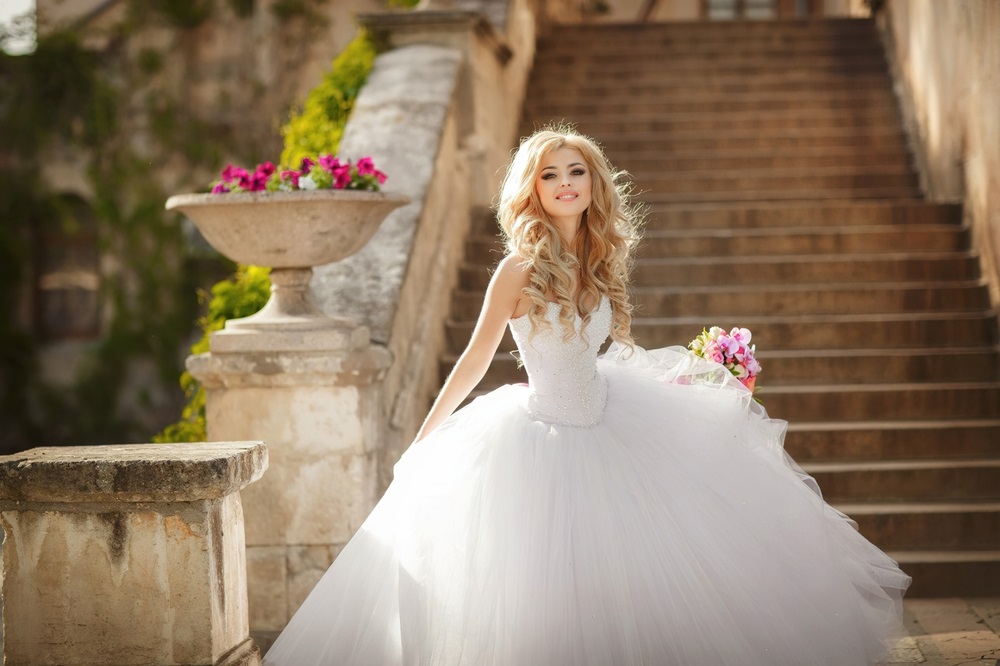 Bride in a wedding dress designed to hide belly imperfections.