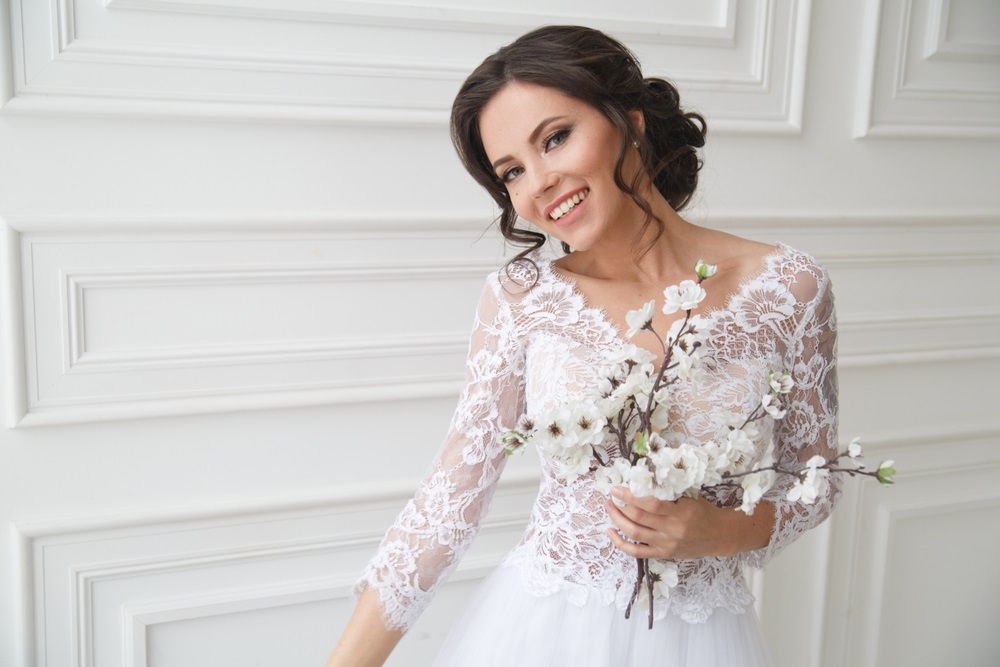 Bride in a wedding dress designed to hide belly imperfections.