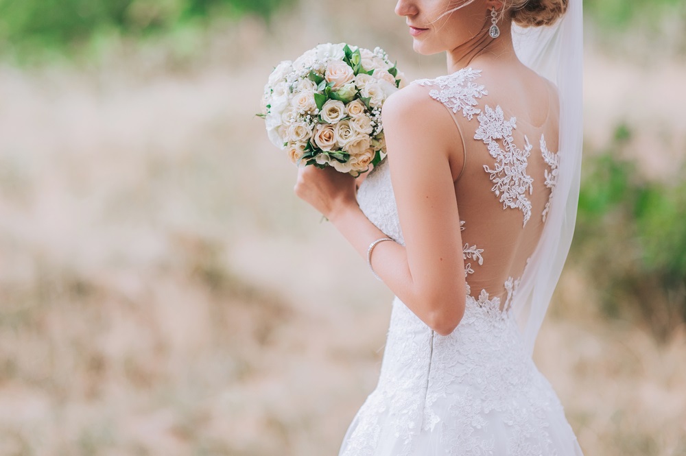 Bride in a wedding dress designed to hide belly imperfections.