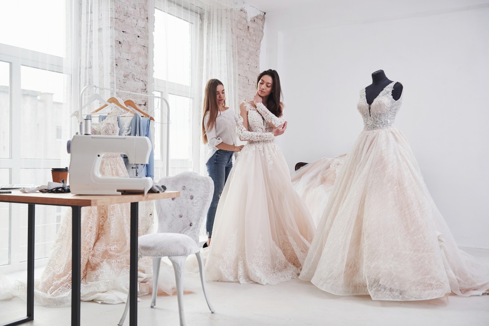 a Bride looking for a wedding dress alteration timeline during an alteration fitting session.