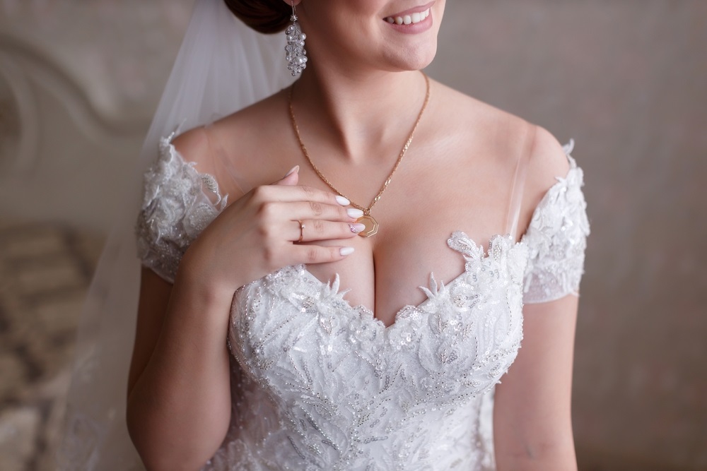 Bride showcasing wedding dress neckline alterations for a perfect fit.