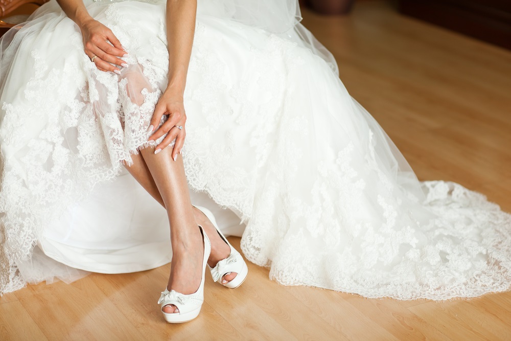 A seamstress expertly hemming a wedding dress for the perfect bridal fit