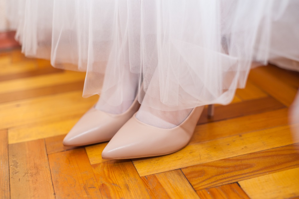 A seamstress expertly hemming a wedding dress for the perfect bridal fit